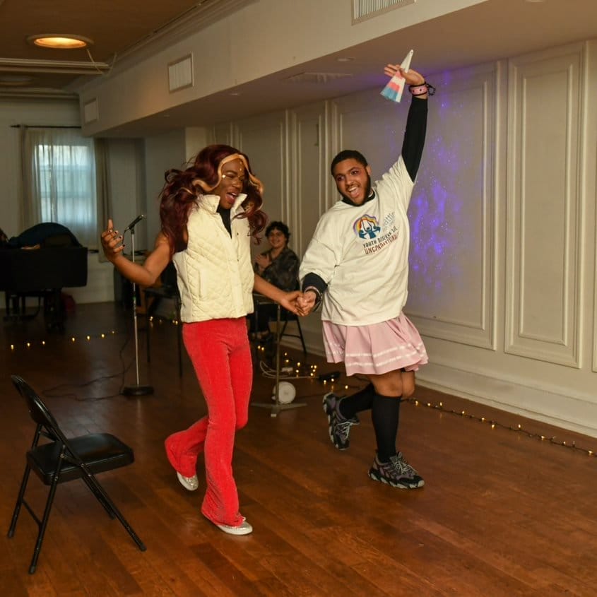 Two youth dancing together during a drag performance